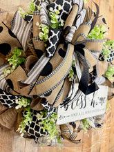 Load image into Gallery viewer, Farmhouse Bless This Home Wreath with Neutral Burlap, Black and White Ribbon, and Greenery – Approx 25 Inch Door Wreath