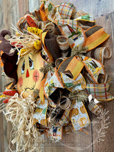 Load image into Gallery viewer, Scarecrow Wreath with Fall Ribbons and Raffia – 28x25 Inches
