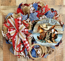 Load image into Gallery viewer, Rodeo Life Western Cowboy Wreath – Patriotic Cow Print &amp; Bandana Mesh Door Decor
